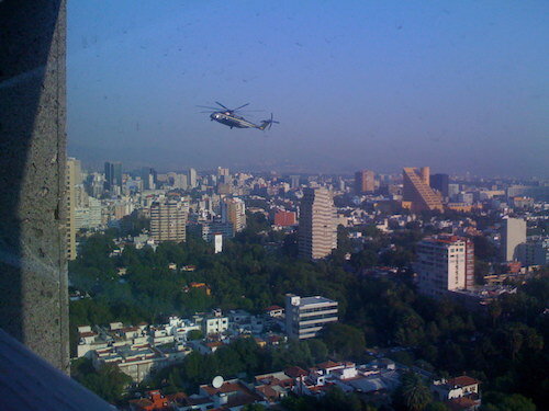 A view out the window from the shower, with a US military helicopter flying nearby