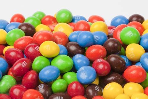 A pile of assorted M&Ms, probably peanut